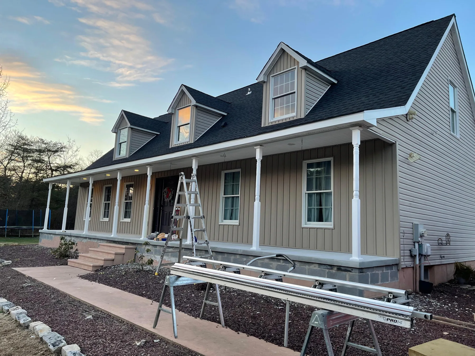 CP Roofing house exterior project with dark roof, siding and front porch